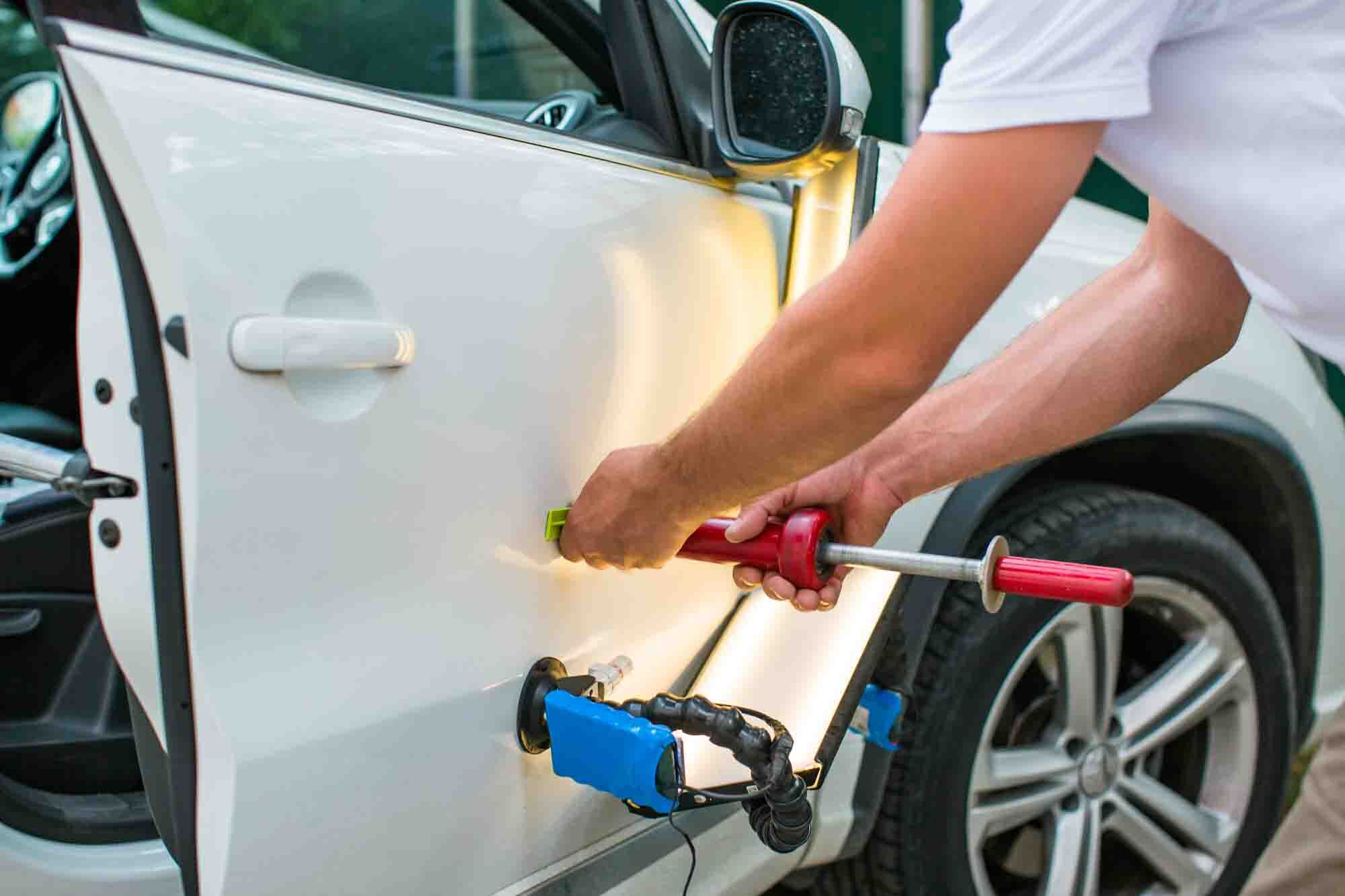Repairing car dent after the accident by paintless dent repair Repairing car dent after the accident by paintless dent repair
